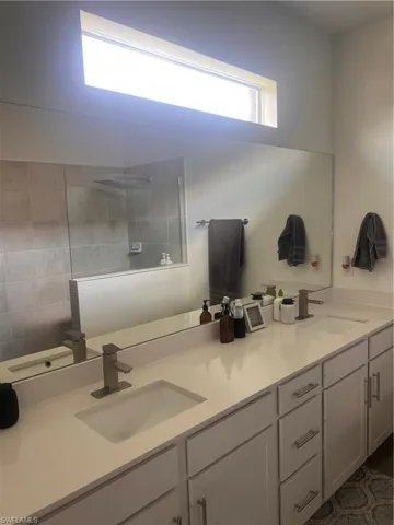 Full bath featuring double vanity