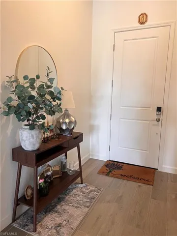 Foyer entrance with baseboards and wood finished floors