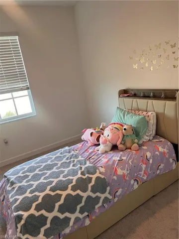 Carpeted bedroom with baseboards