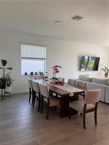 Dining room featuring light wood finished floors and baseboards