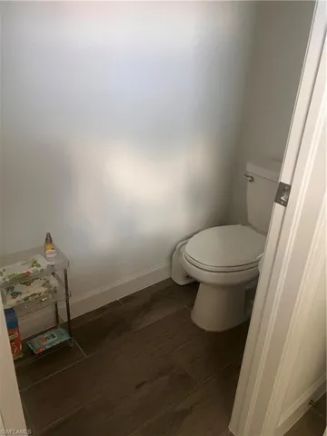 Bathroom with baseboards and wood-style flooring
