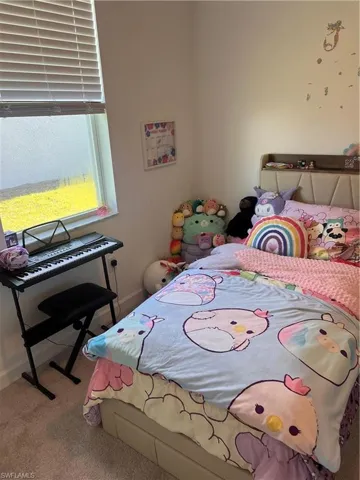 Bedroom featuring carpet flooring and baseboards