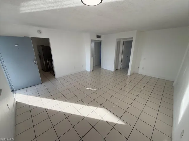 Spare room featuring a textured ceiling and light tile patterned flooring