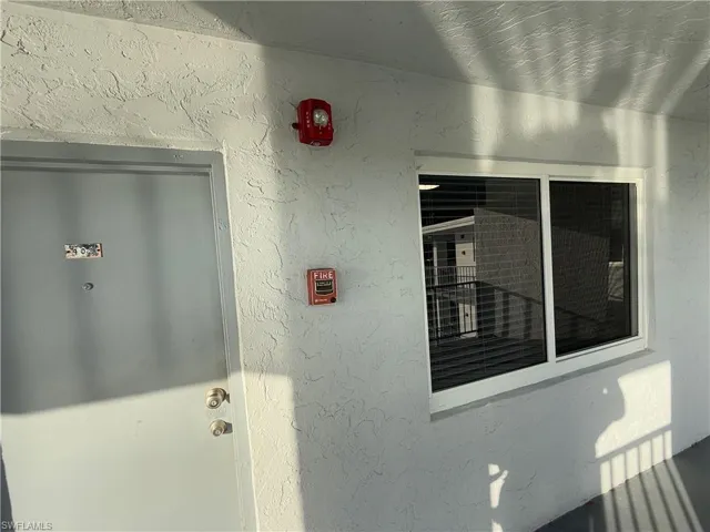 View of exterior entry with stucco siding
