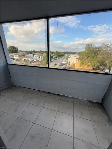 Balcony featuring a sunroom and a residential view