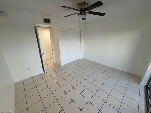 Unfurnished bedroom with a closet and a ceiling fan
