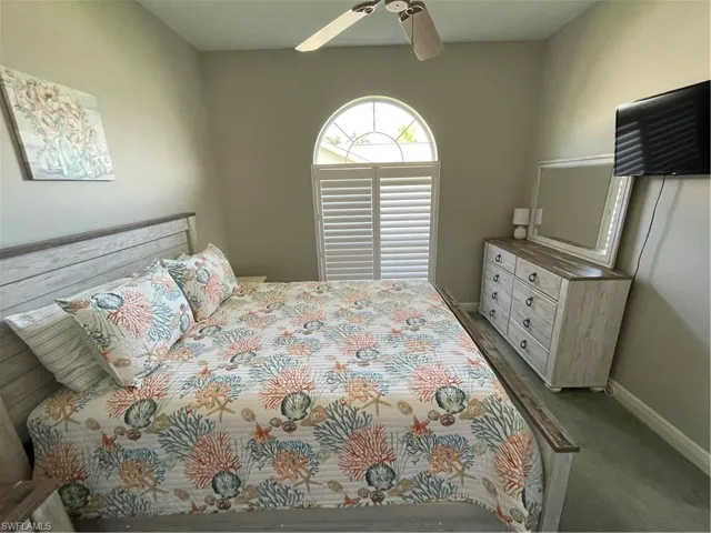 Middle Bedroom with a ceiling fan, baseboards, and carpet floors