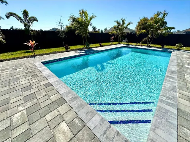 View of pool featuring a fenced backyard and patio surround
