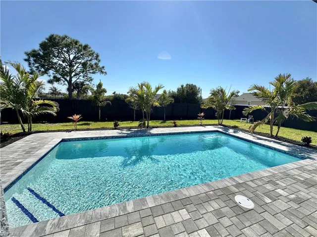 View of pool with a fenced backyard and patio surround