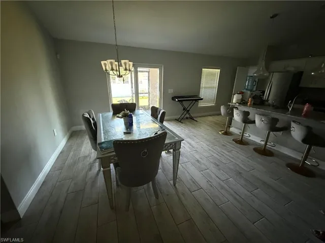 Dining room with a chandelier and light wood finished floors