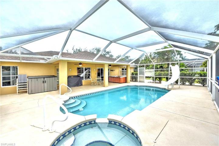 Beautiful lake, front pool and spa with large covered lanai area