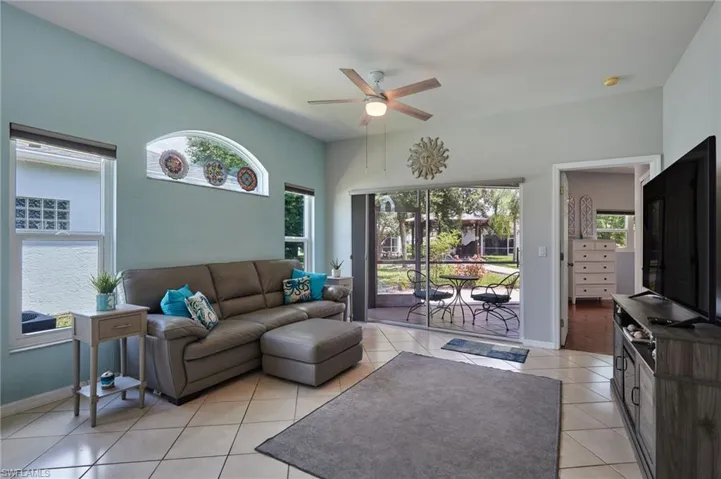 Living area featuring ceiling fan and light tile patterned floors