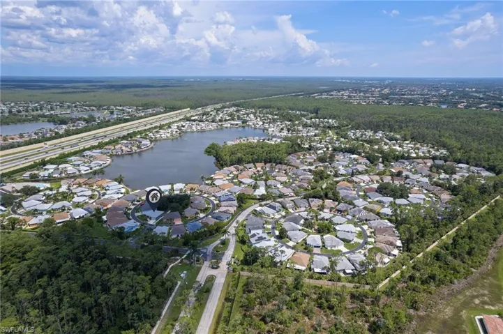 Aerial overview of property's location featuring a large body of water and nearby suburban area