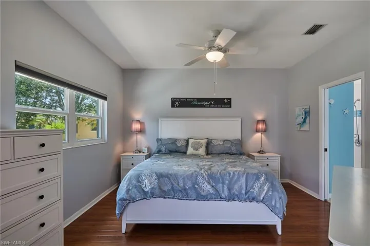 Bedroom with dark wood finished floors and a ceiling fan