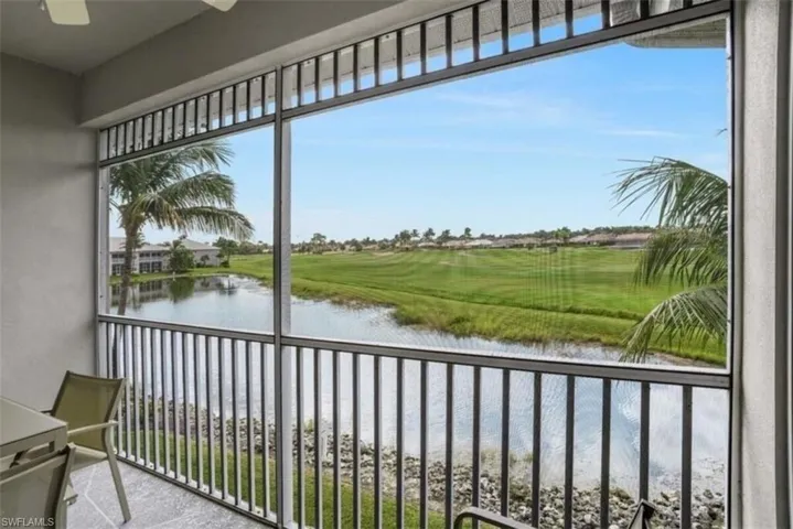 Balcony featuring a water view and a sunroom