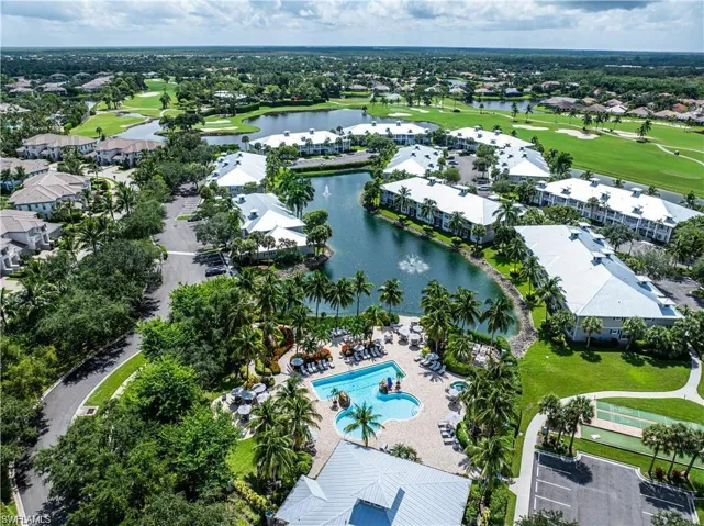 Aerial perspective of suburban area with a golf course and a nearby body of water