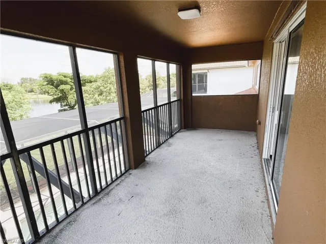 Unfurnished sunroom with a water view