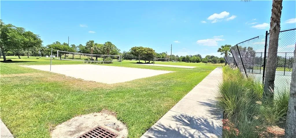 View of community featuring volleyball court and a lawn