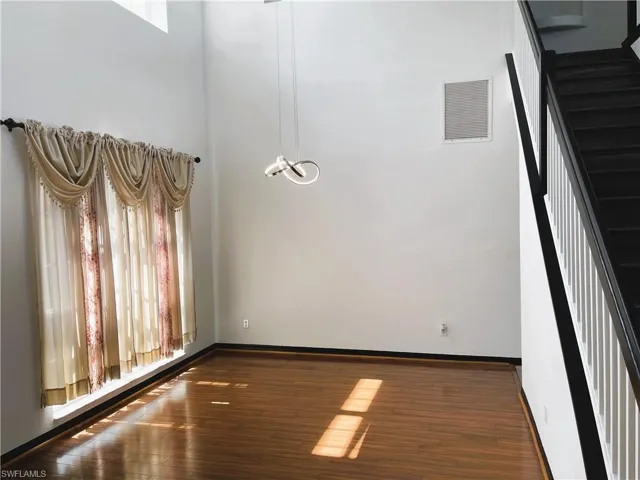 Unfurnished room featuring dark wood-type flooring