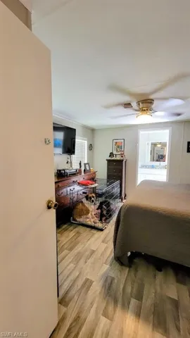 Bedroom featuring ceiling fan and hardwood / wood-style floors