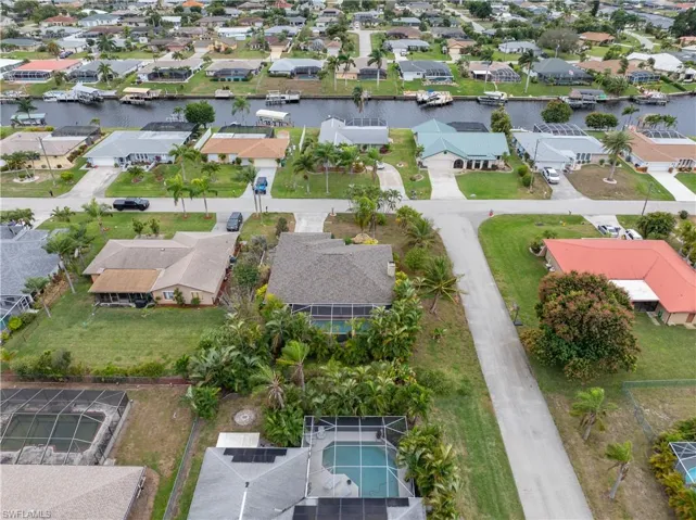 Aerial view of residential area featuring a large body of water