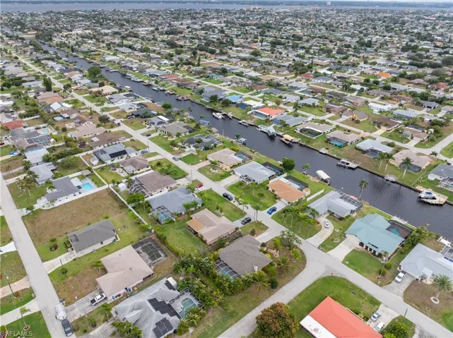 Aerial overview of property's location featuring a nearby body of water and nearby suburban area
