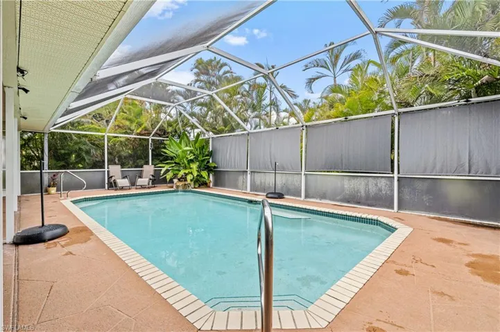 Outdoor pool with a patio, a lanai, and a sunroom
