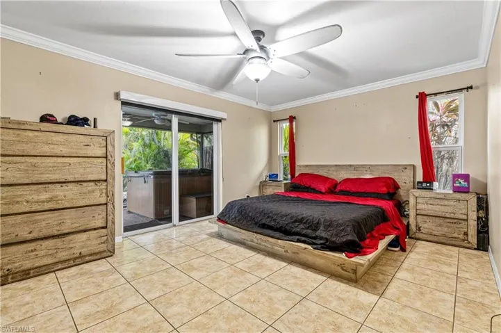 Main Bedroom featuring crown molding, access to outside, light tile patterned floors, and a ceiling fan and access to pool area
