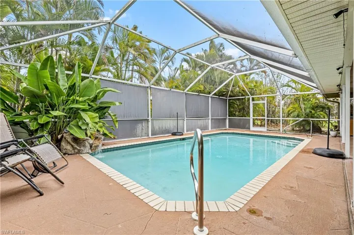 Outdoor pool with a patio area, a lanai, and a sunroom