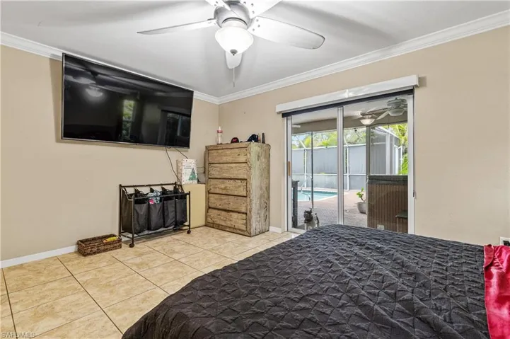 Main Bedroom featuring ornamental molding, access to outside, a ceiling fan, and tile patterned floors