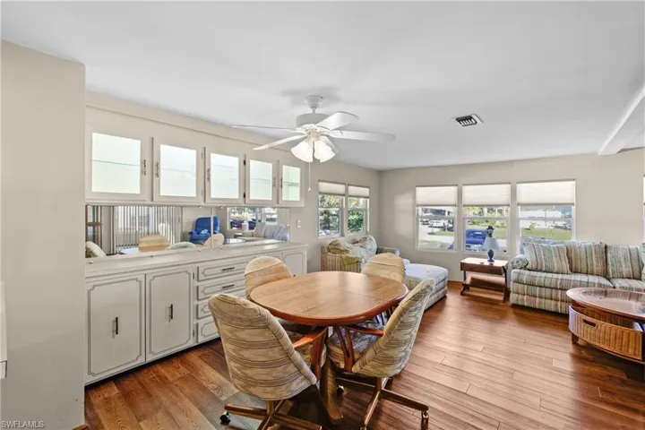 Dining area featuring wood-type flooring and ceiling fan