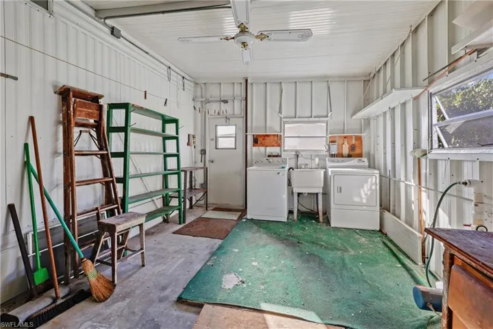 Washroom featuring washer and dryer, ceiling fan, and sink