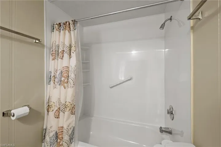 Bathroom featuring shower / bath combination with curtain