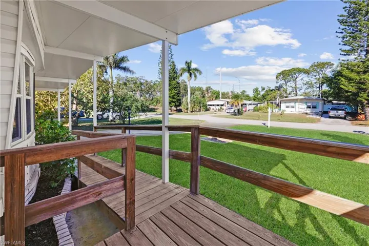 Deck with covered porch and a yard