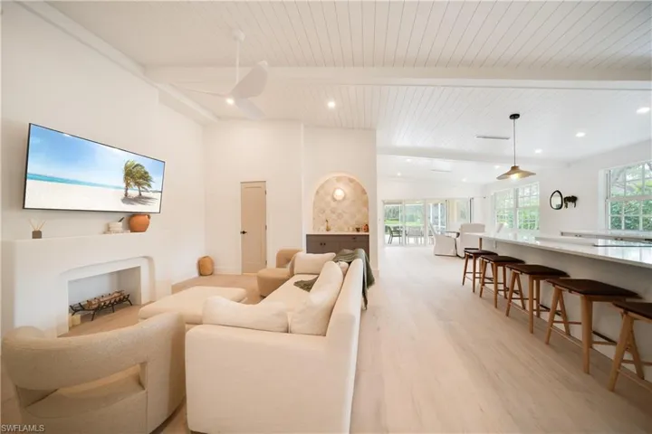 Living area with recessed lighting, wood ceiling, lofted ceiling with beams, and light wood finished floors