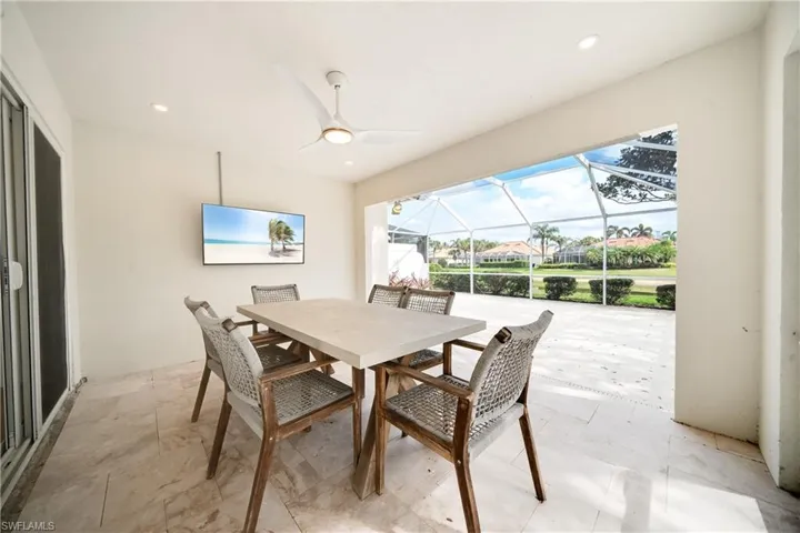 Dining room with a sunroom, a ceiling fan, and recessed lighting