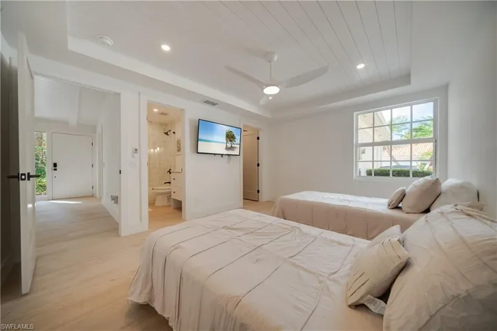 Bedroom with recessed lighting, wood ceiling, baseboards, light wood-type flooring, and a tray ceiling
