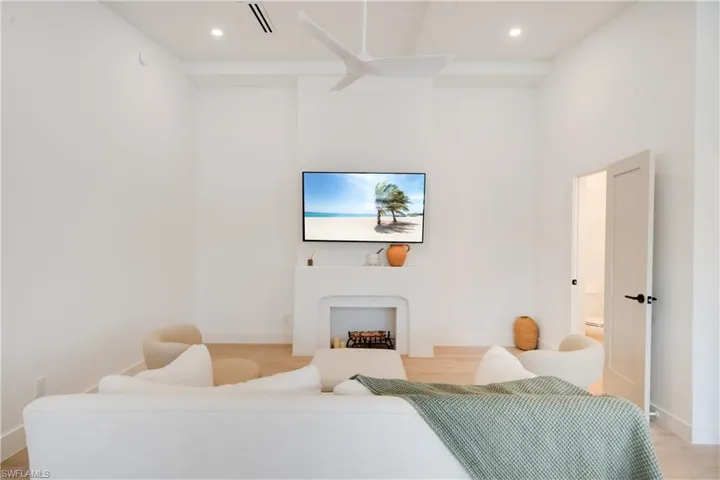 Living area featuring recessed lighting, baseboards, visible vents, and light wood finished floors