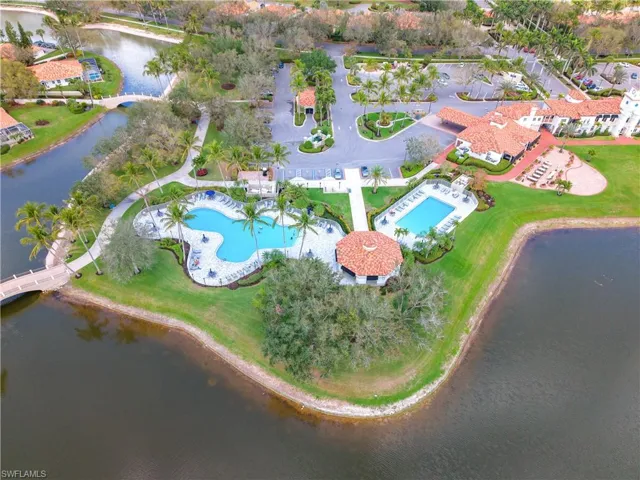 Birds eye view of property with a water view