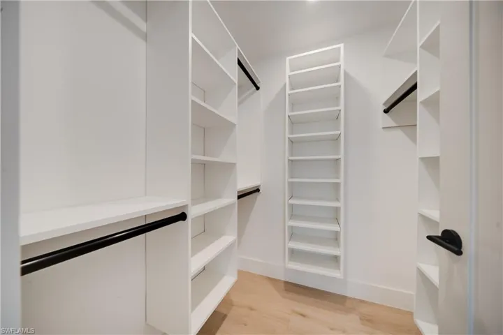 Walk in closet featuring light wood-type flooring