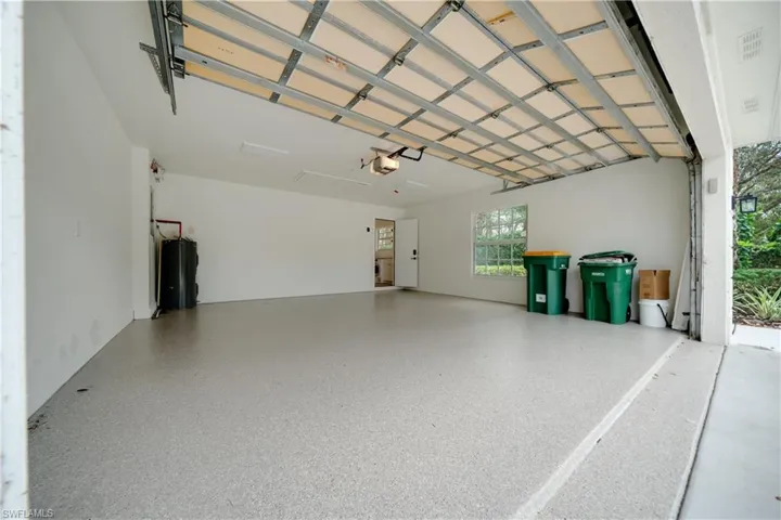Garage with a garage door opener and electric water heater