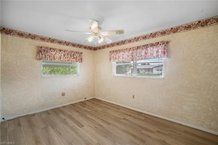 Empty room featuring ceiling fan and wood-type flooring