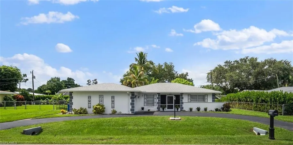 Single story home with a front lawn