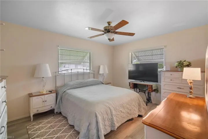 Bedroom featuring wood-type flooring and ceiling fan