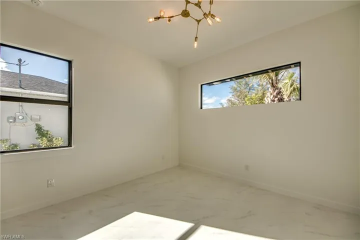 Spare room featuring a notable chandelier