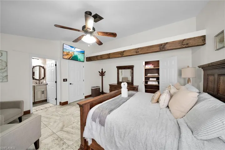 Bedroom with ceiling fan and connected bathroom