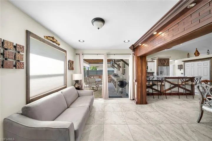 Living area with recessed lighting and a sunroom