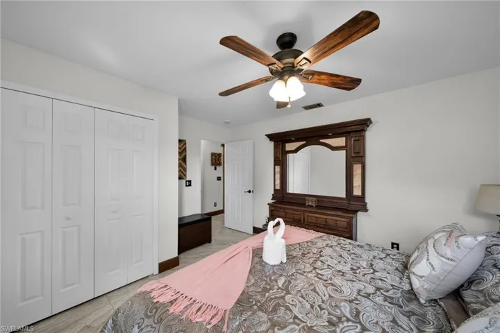 Bedroom featuring a ceiling fan and a closet