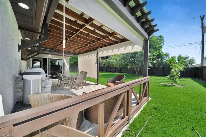 Wooden deck featuring a patio area, outdoor dining area, and a fenced backyard