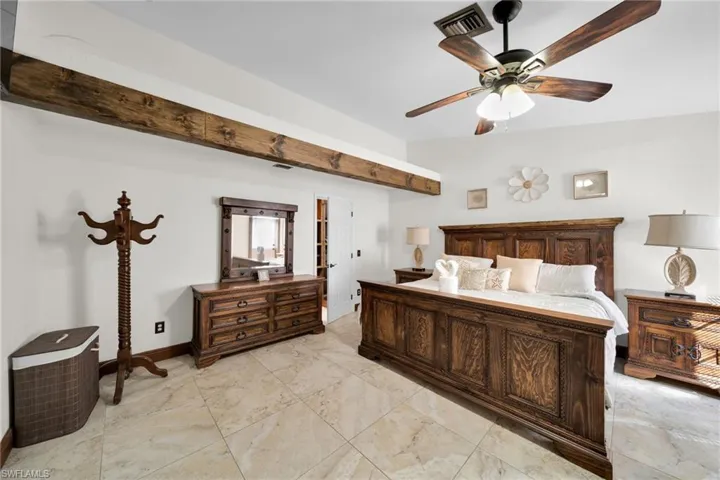 Bedroom featuring ceiling fan and baseboards